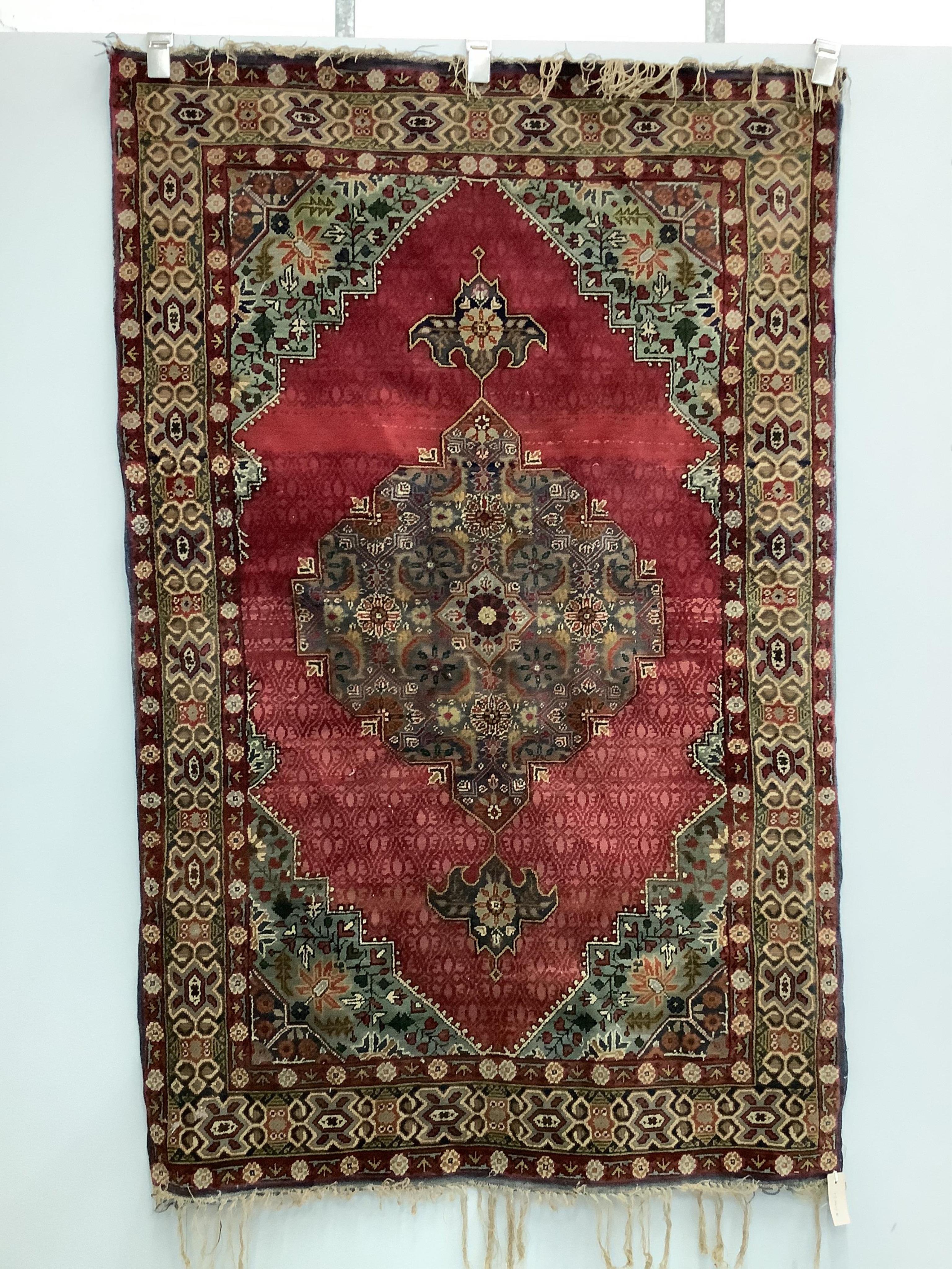 A North West Persian red ground rug, 170 x 106cm. Condition - faded and worn at the fringes